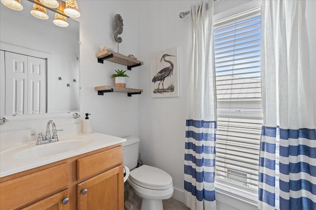 bathroom featuring vanity and toilet