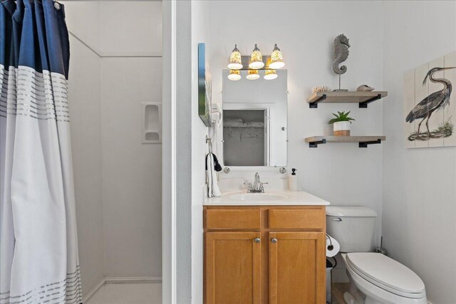 bathroom with tile patterned floors, vanity, and toilet