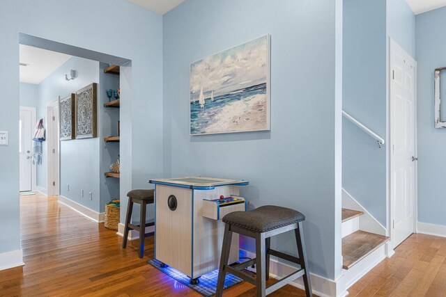 hallway with hardwood / wood-style flooring