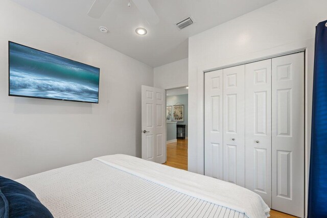 bedroom featuring a closet, ceiling fan, and wood-type flooring