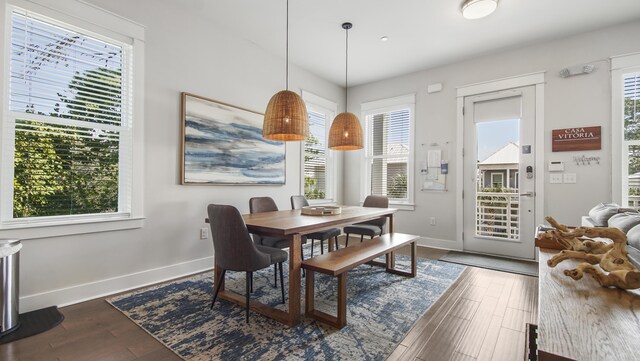 dining space with wood-type flooring