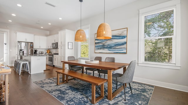 dining room with sink and dark hardwood / wood-style flooring