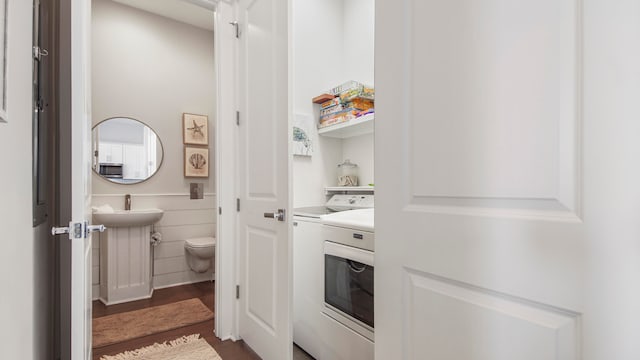 interior space featuring sink, washing machine and dryer, and hardwood / wood-style floors