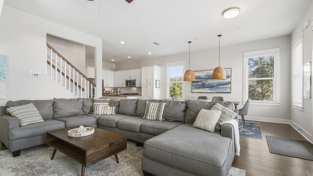 living room featuring ceiling fan and hardwood / wood-style floors