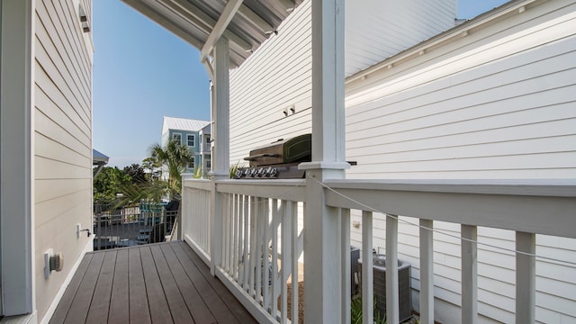 wooden terrace featuring central AC unit