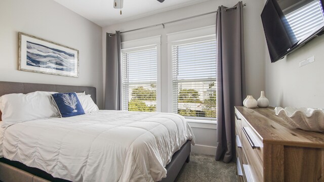 bedroom featuring ceiling fan and dark carpet