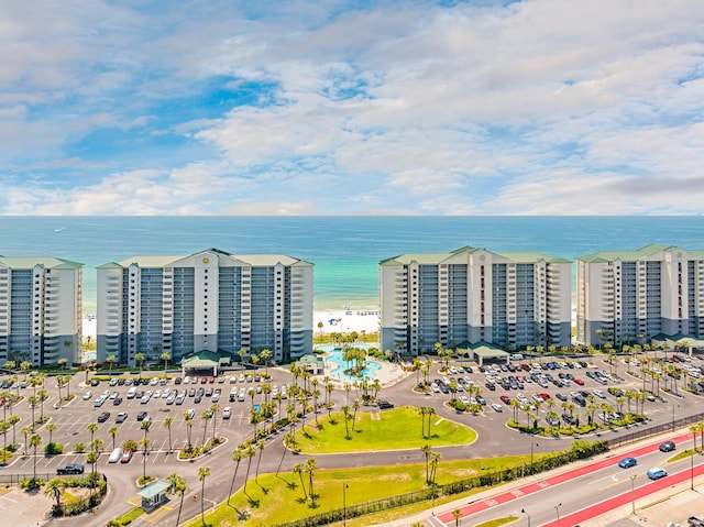 birds eye view of property featuring a beach view, a water view, and a city view