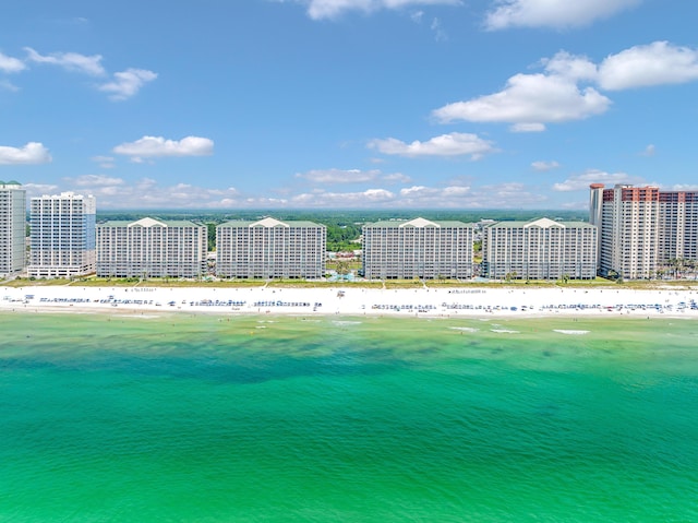 drone / aerial view featuring a view of the beach, a water view, and a city view