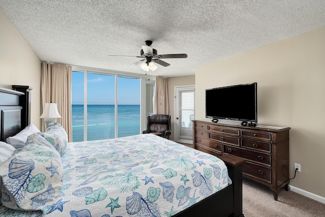 bedroom featuring light colored carpet, ceiling fan, a textured ceiling, access to outside, and baseboards