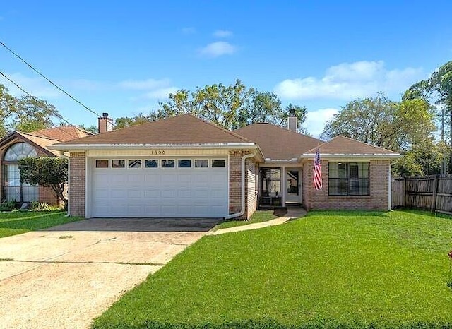 ranch-style home with a front lawn and a garage