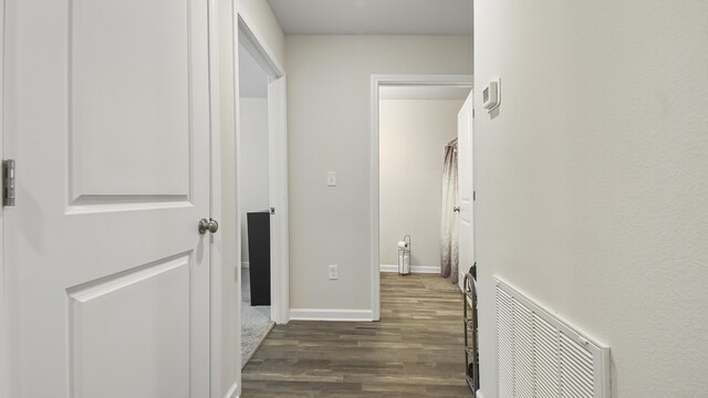 corridor featuring dark hardwood / wood-style floors