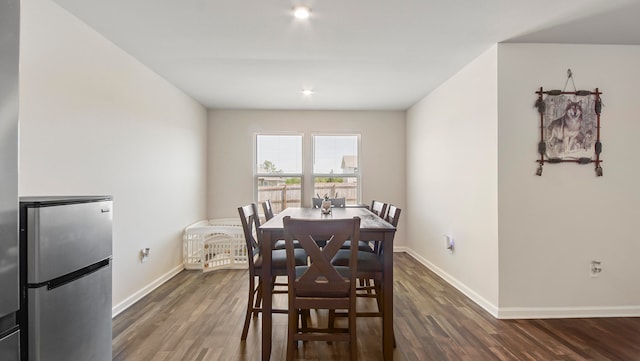 dining space with dark wood-type flooring