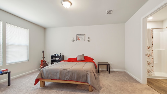 bedroom with light wood-type flooring and multiple windows