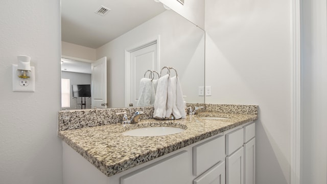 bathroom featuring dual vanity