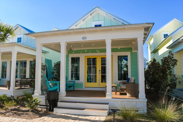 doorway to property featuring french doors and covered porch