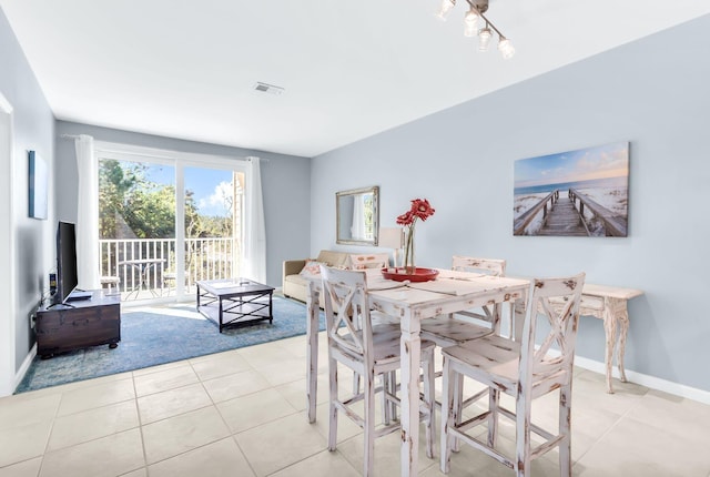 dining space featuring light tile patterned floors