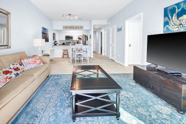 living room featuring rail lighting and light tile patterned flooring