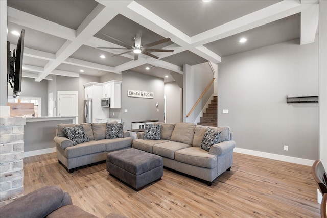 living room with light hardwood / wood-style flooring, ceiling fan, coffered ceiling, and beam ceiling