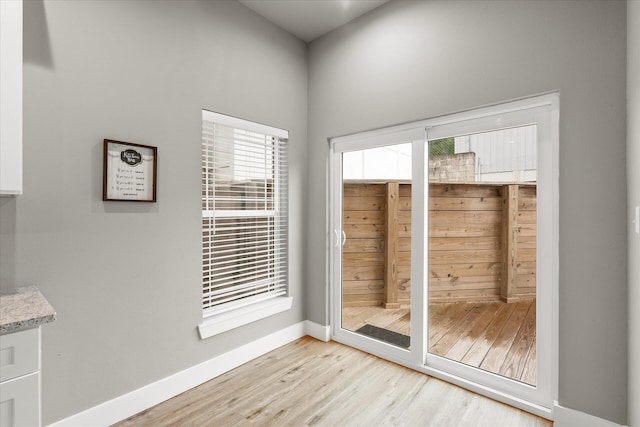 doorway to outside featuring plenty of natural light and light hardwood / wood-style floors