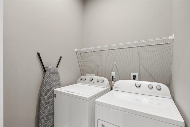 clothes washing area with washing machine and dryer