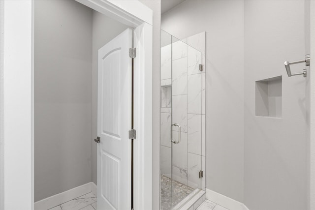 bathroom featuring a shower with door and tile patterned floors