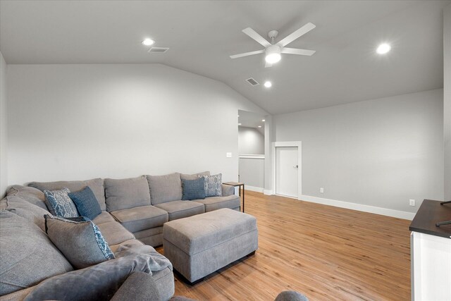 living room featuring vaulted ceiling, ceiling fan, and light hardwood / wood-style floors