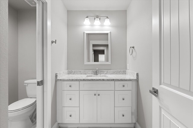 bathroom featuring vanity and toilet