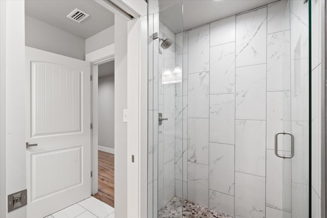 bathroom featuring hardwood / wood-style floors and an enclosed shower