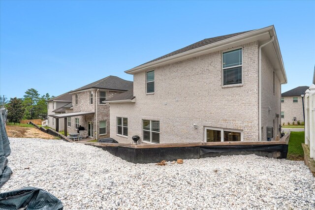 back of house with brick siding