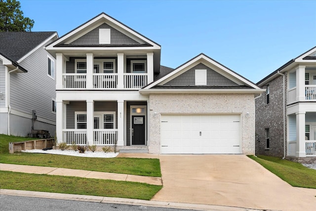 view of front of property with a porch, an attached garage, brick siding, concrete driveway, and a front yard