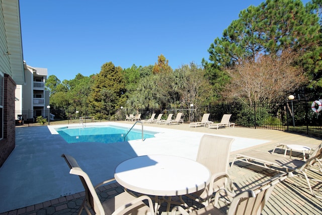 view of swimming pool with a patio