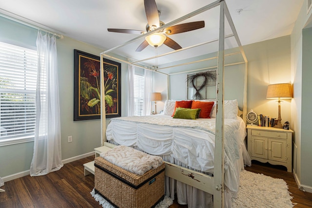 bedroom with multiple windows, dark hardwood / wood-style flooring, and ceiling fan