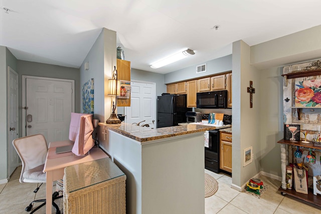 kitchen featuring light stone counters, kitchen peninsula, light tile patterned floors, and black appliances