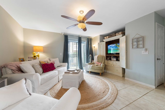 tiled living room with ceiling fan