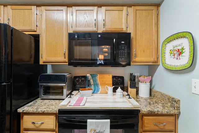 kitchen featuring light stone countertops and black appliances