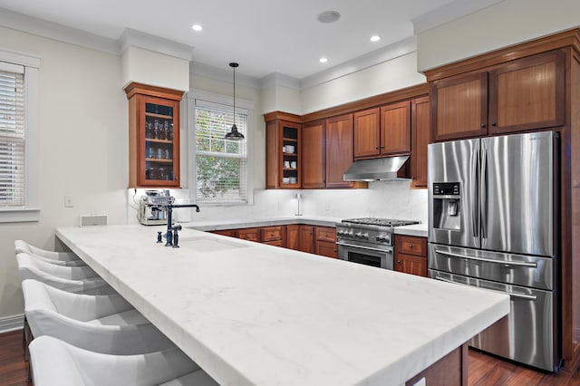 1247 Prospect Promenade, Panama City Beach, FL 32413 - kitchen with sink, kitchen peninsula, pendant lighting, a breakfast bar area, and appliances with stainless steel finishes