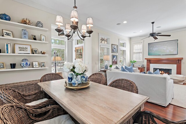 1247 Prospect Promenade, Panama City Beach, FL 32413 - dining room with ceiling fan with notable chandelier, dark hardwood / wood-style floors, and ornamental molding