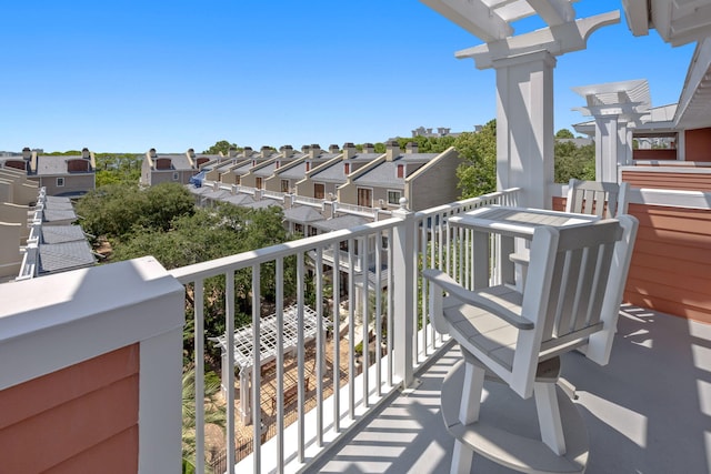 balcony featuring a residential view and a pergola