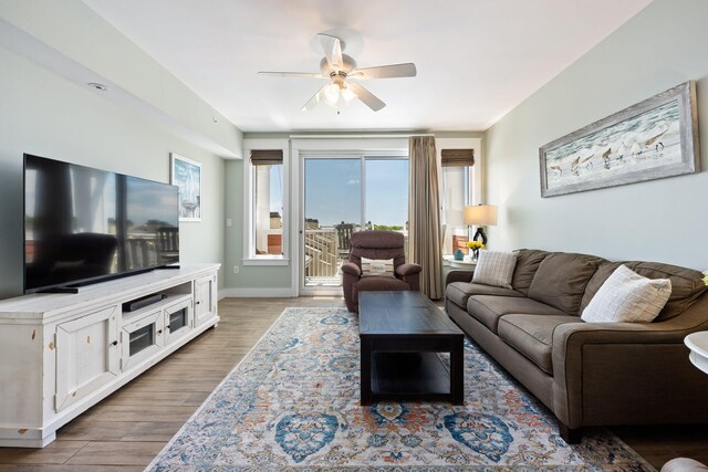 living room with light wood-type flooring and ceiling fan