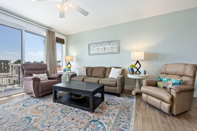 living room with ceiling fan and hardwood / wood-style floors