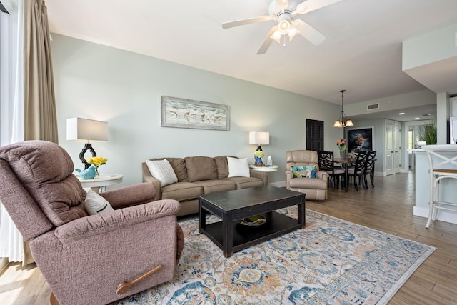 living room with ceiling fan and light wood-type flooring