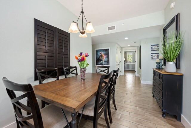 dining room featuring light hardwood / wood-style flooring and a chandelier