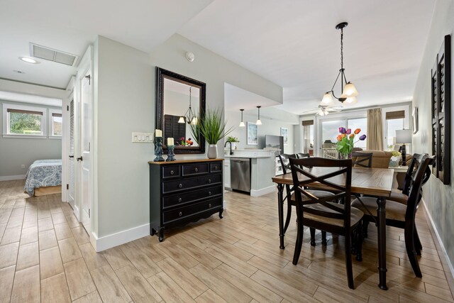 dining area featuring ceiling fan and light wood-type flooring