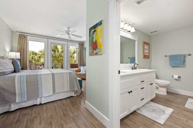 bedroom with ceiling fan, sink, and light hardwood / wood-style floors