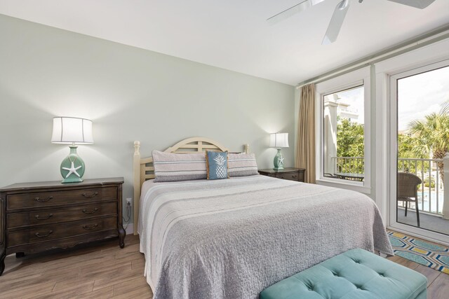 bedroom with light hardwood / wood-style flooring, ceiling fan, and access to exterior