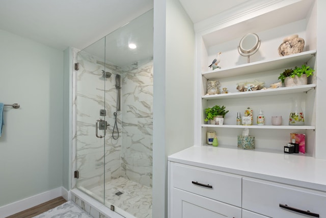 bathroom featuring vanity, a shower with shower door, and hardwood / wood-style floors