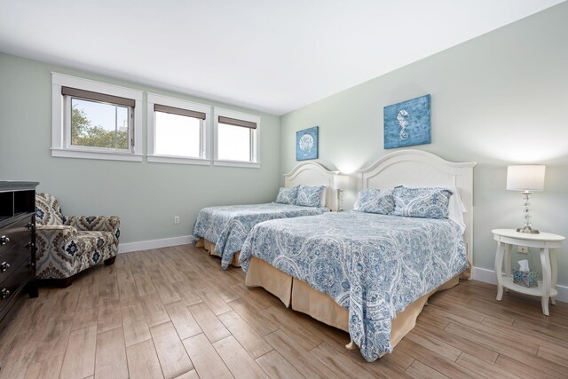 bedroom featuring light wood-type flooring and multiple windows