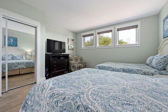 bedroom with a closet and light hardwood / wood-style floors