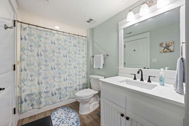 full bathroom featuring shower / tub combo, toilet, vanity, and hardwood / wood-style floors