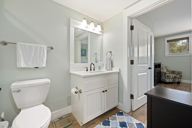 bathroom featuring vanity, hardwood / wood-style floors, and toilet